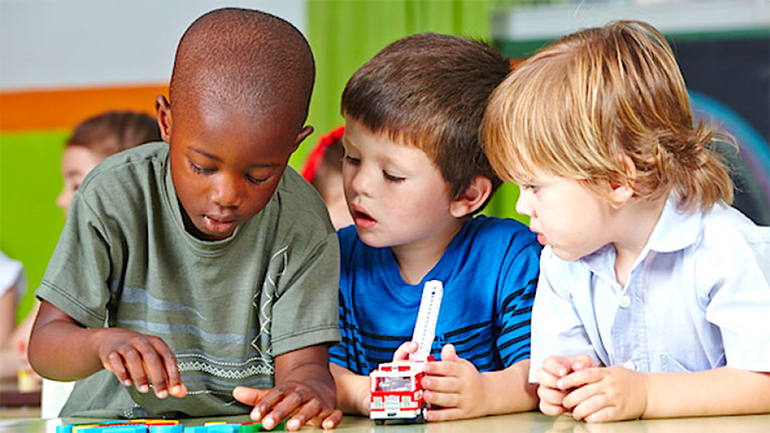 three kids in the classrom